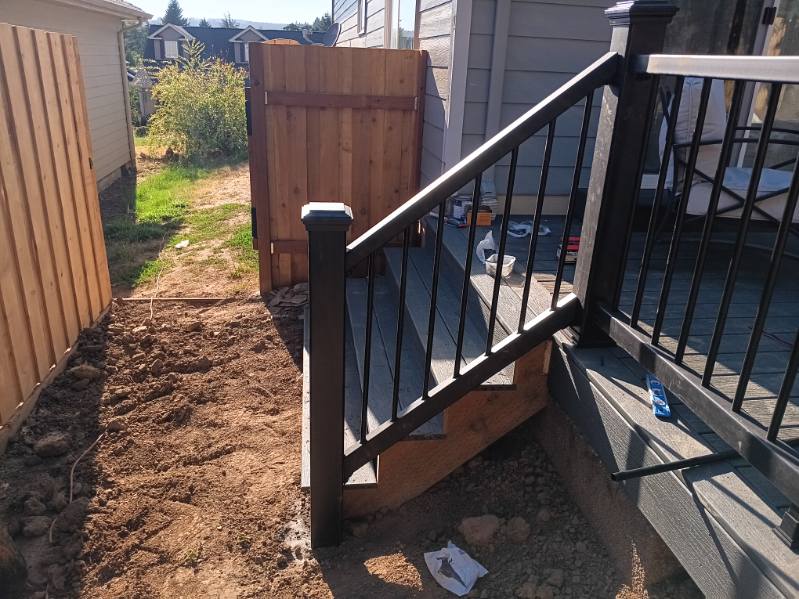 Composite deck and steps with black metal railing built in Hillsboro, Oregon by 360 Custom Construction, vetted by On Top Home Services
