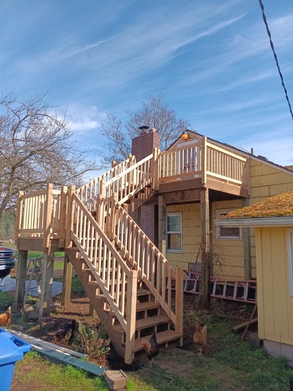 Elevated multi-level deck with staircase on a hillside home in Oregon City, Oregon, built by 360 Custom Construction and vetted by On Top Home Services
