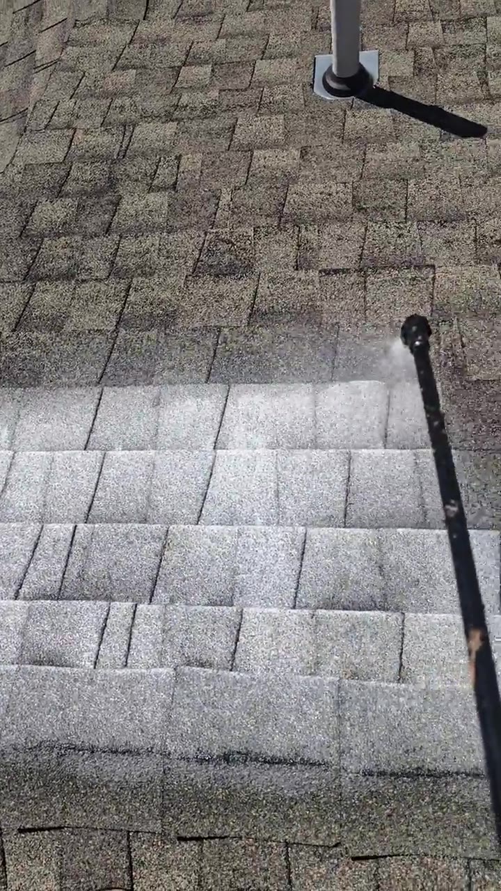 Spray wand applying APEX-1132 roof rejuvenation to asphalt shingles below a roof vent — after treatment